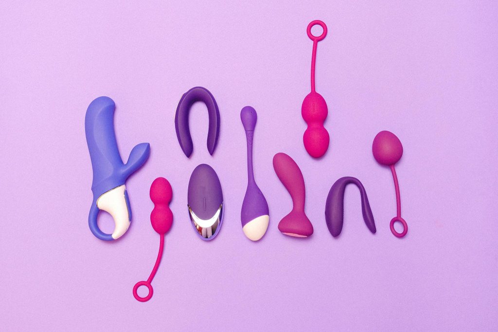 Various silicone sex toys displayed on a purple background for pleasure and education.